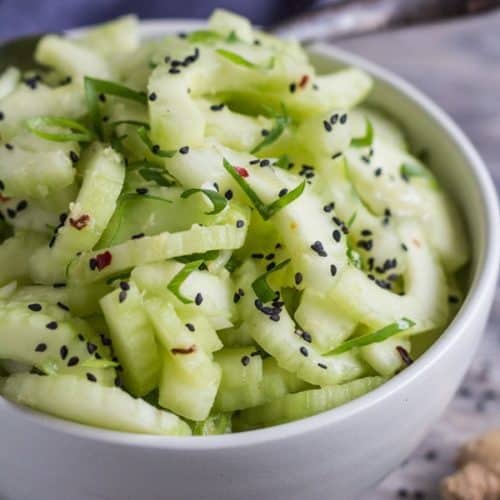 Sweet and Spicy Cucumber Ginger Salad in a bowl with black sesame seed sprinkle