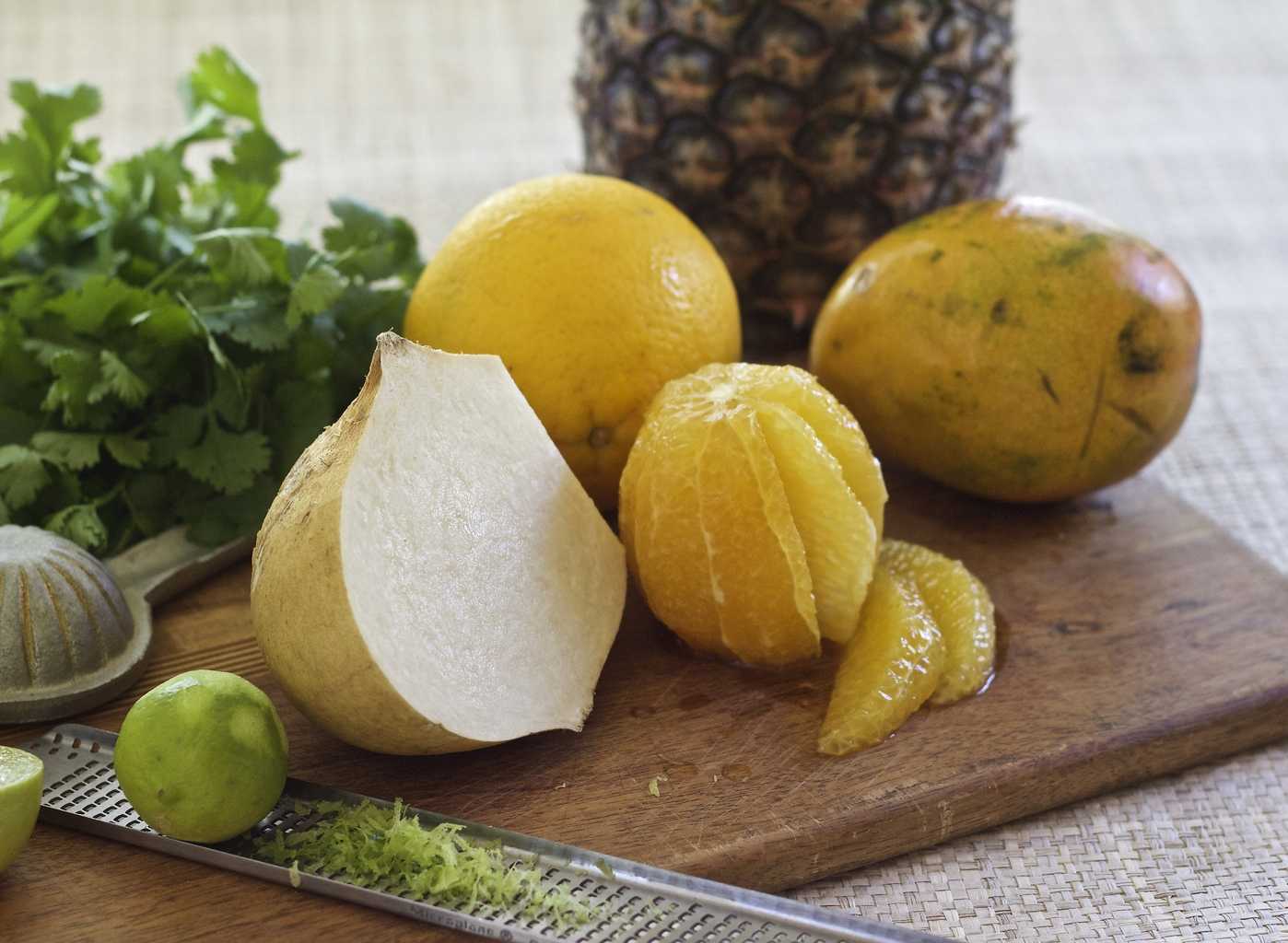 Jicama, Cilantro and Lime, mango orange and pineapple on wooden board