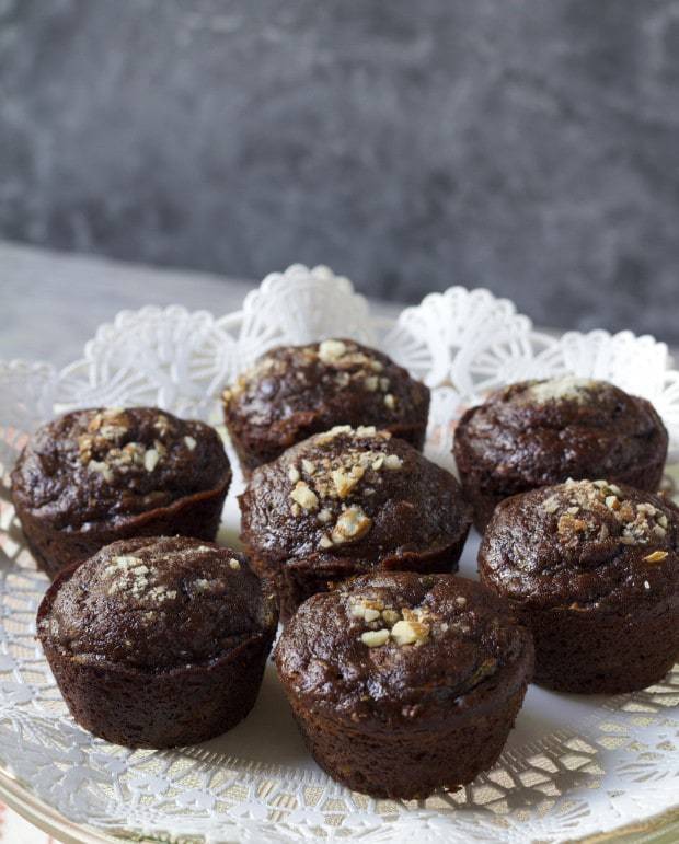 Chocolate Zucchini Muffins on plate with white doily