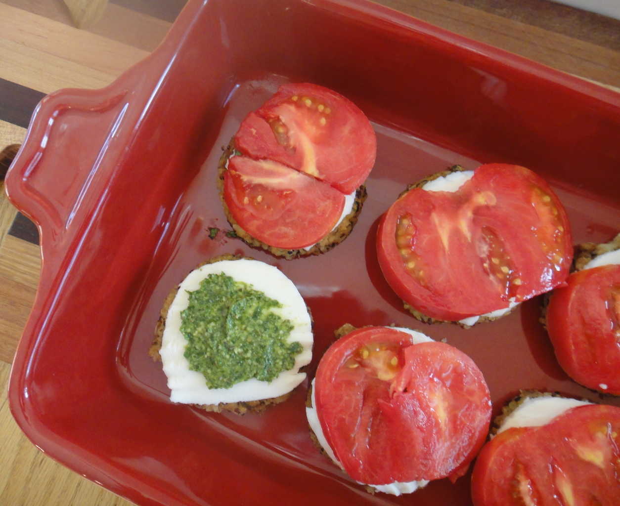 layers of veggie patties with mozzarella cheese, tomatoes and basil pesot
