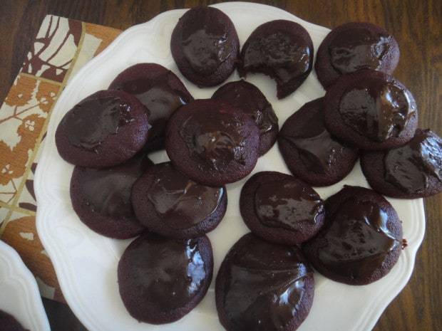 Chocolate-glazed Red Velvet Chocolate Beet Cookies on a white plate