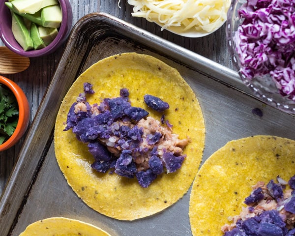 Assembling Purple Potato and Bean Tacos on a sheet pan