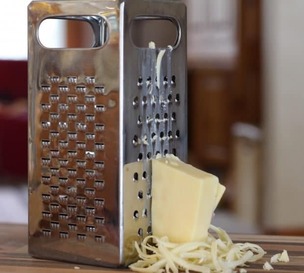 grating cheese for Green Chile and Cheese Corn Muffins