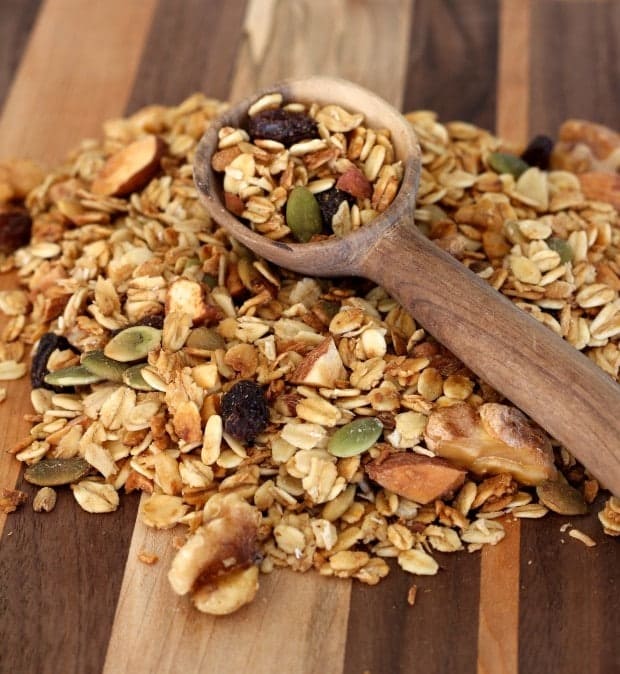 granola on a board with wooden spoon