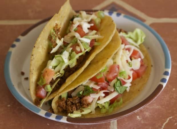 Two tacos on plate ready to eat 