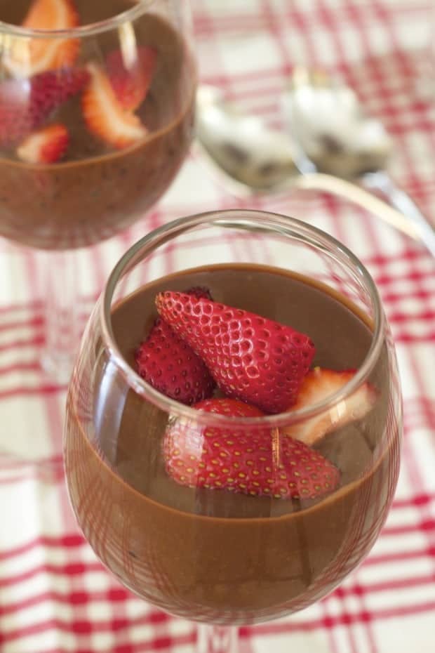 Dark Chocolate Tapioca Pudding with strawberries in wine glasses with red check tablecloth