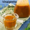 red wine herb vinaigrette in pitcher with bottle of dressing in background with text for Pinterest