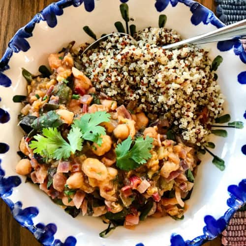 Chard and chickpea curry with quinoa in blue-edge bowl