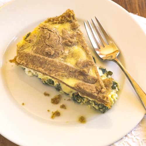 cut slice on plate of Spinach and Goat Cheese Upsde Down Quiche