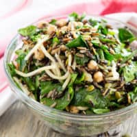 Wild Rice Arugula Salad with Chickpeas in a glass bowl ready to serve