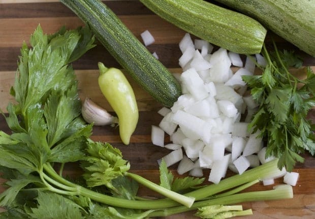 ingredients for spicy zucchini rice soup chile, onion, parsley, celery, zucchini and garlic