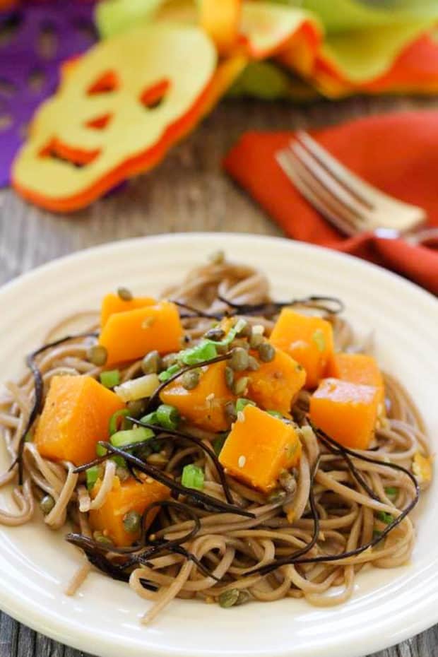 Butternut Squash and Soba Noodles on white plate with orange napkin 