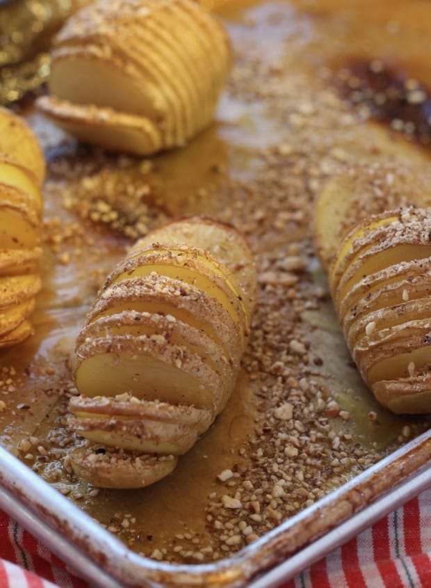 Hasselback Potatoes with Dukkah Spice on baking sheet