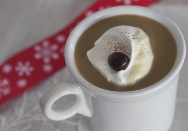 Closeup of White Chocolate Mocha in a mug, with whipped cream and coffee bean garnish