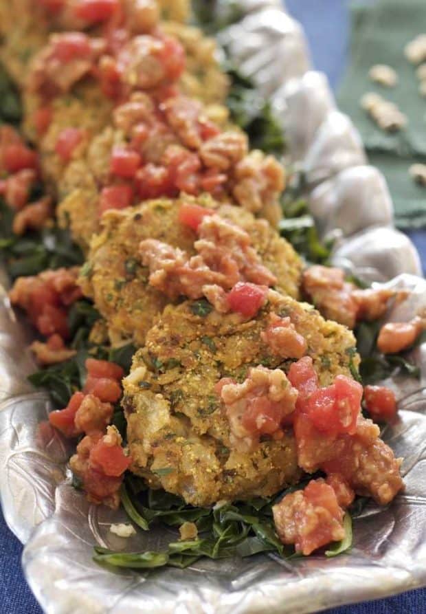 close up shot of black-eyed peas and collard greens --Hoppin’ John fritters with ‘soysage’ and tomatoes