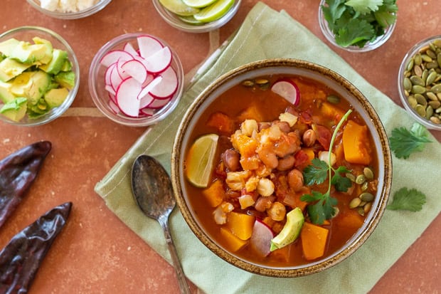 Butternut Squash Pozole in soup bowl, garnished and ready to eat