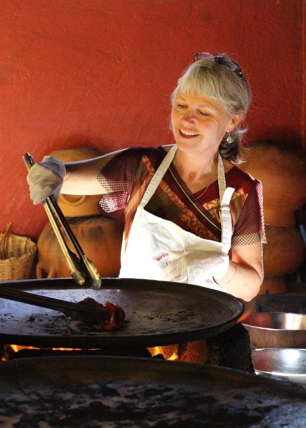 Letty toasting chiles on a comal at Seasons of My Heart cooking School in Oaxaca Mexico