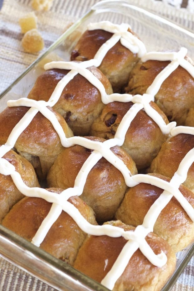 Gingery Whole Wheat Hot Cross Buns baked in pan with cream cheese frosting cross on top