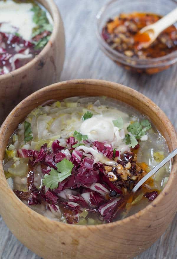 Chicory Soup with Barley and Lemon in soup bowl with relish