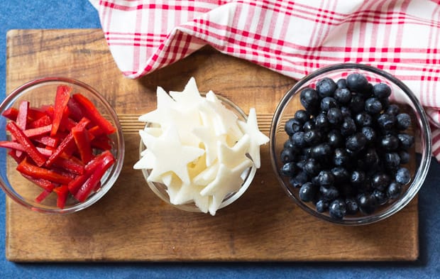 red pepper strips, jicama stars and blueberries in bowls
