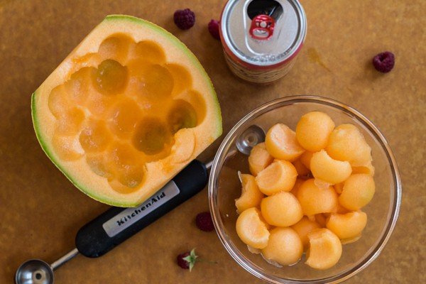 scooping cantaloupe balls for Melon Raspberry Soda Float 