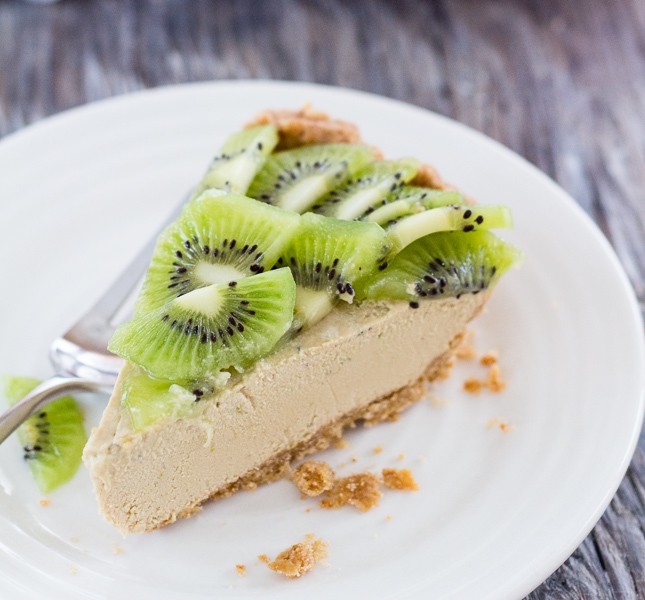 one wedge slice on white plate of Lime Avocado Pie with kiwi fruit arranged on top