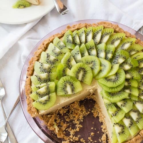 Creamy Vegan Kiwi Limoverhead shot of Kiwi Lime Avocado Pie with pieces out and slice on plate in background