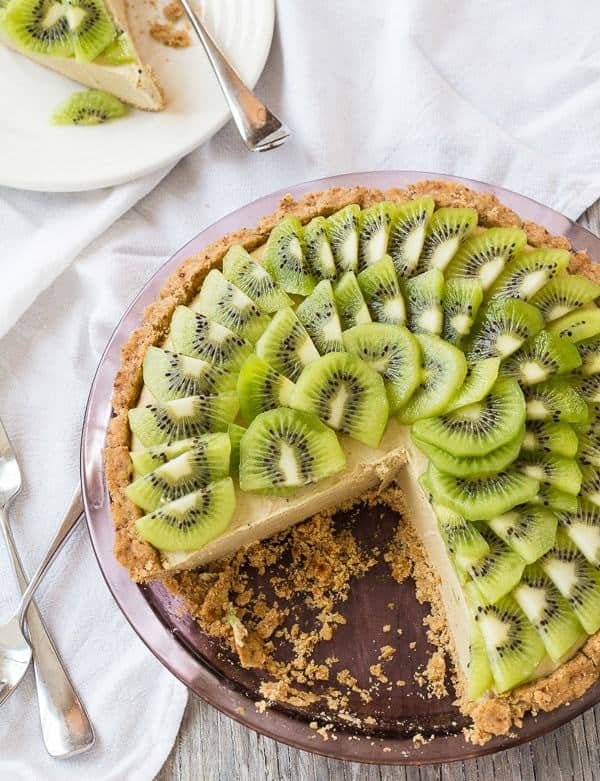 overhead shot of Kiwi Lime Avocado Pie with pieces out and slice on plate in background
