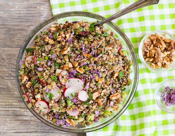 French Green Lentil and Quinoa Salad overhead in glass bowl on green checked napkin
