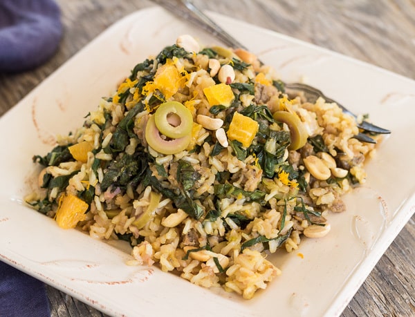 Brown Rice Pilaf with Bitter Greens, Olives, and Orange on plate rectangle