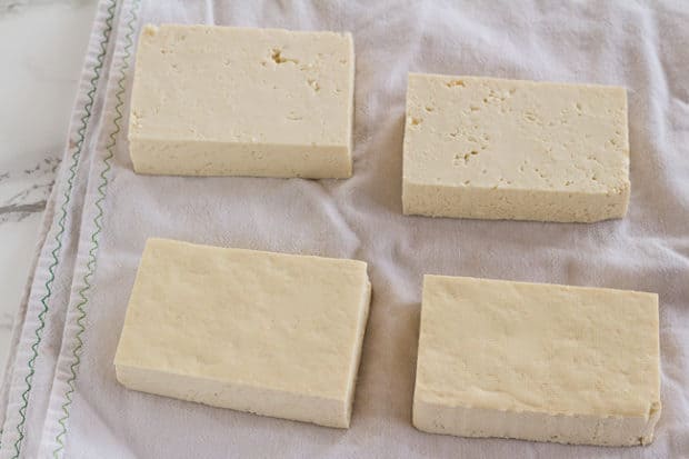 draining tofu slabs for Thai Peanut Noodles with Golden Tofu