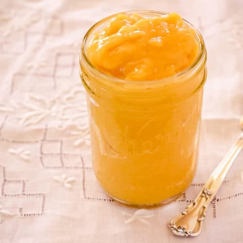 Lemon curd in jar with knife