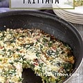 Frittata in skillet with one wedge out with text for Pinterest